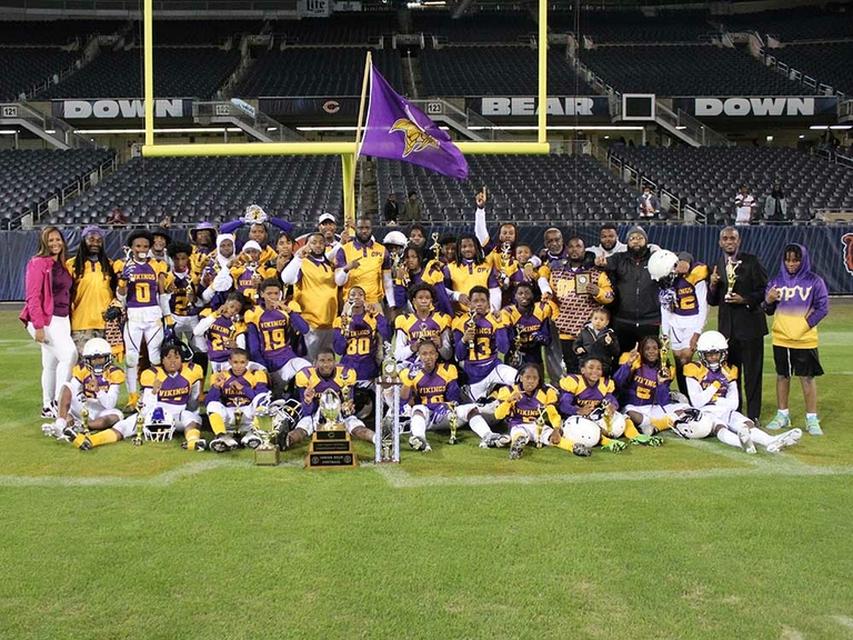 Youth football team celebrates championship win on field.