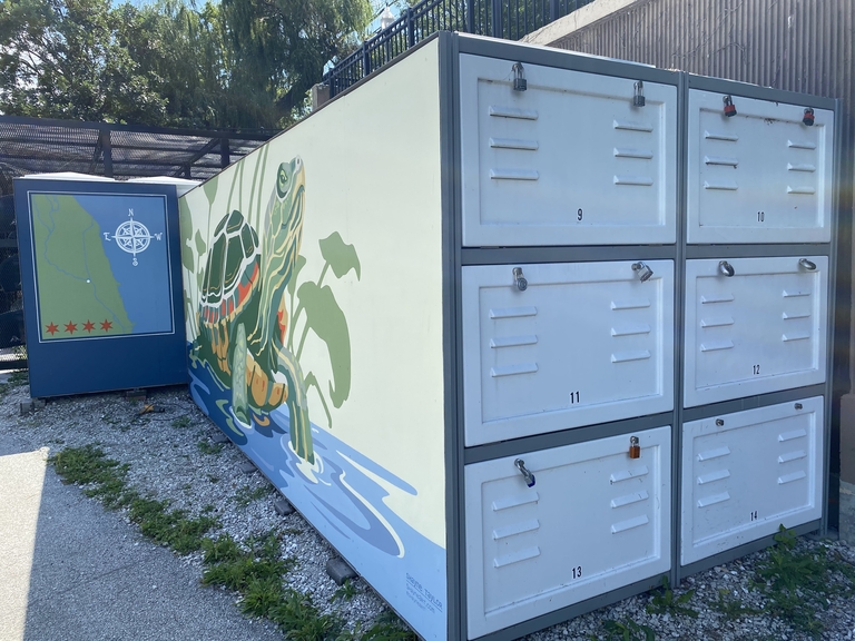 Photograph of boat lockers with a painted turtle and map.