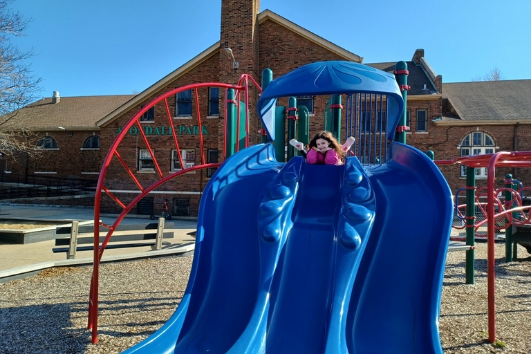 Girl coming down a double blue slide at A.O. Dahl Park playground.