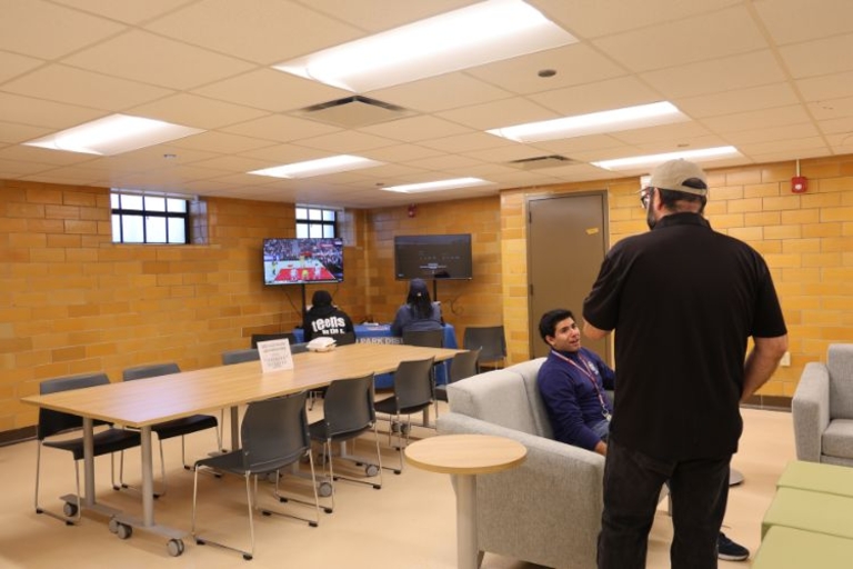 Student lounge area with TVs and seating.