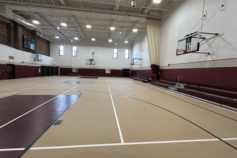 Empty indoor gymnasium with basketball court.