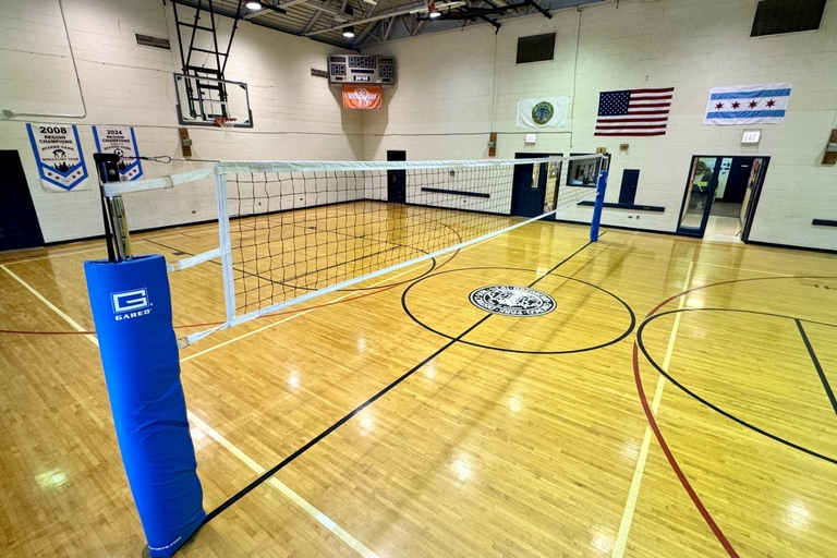 Photograph of volleyball net in a school gymnasium.