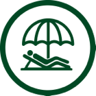 Person relaxing on a beach chair under a parasol.
