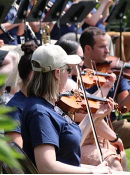 Violinists playing outdoors.