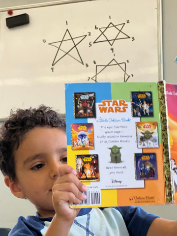Child holding a Star Wars Little Golden Book.