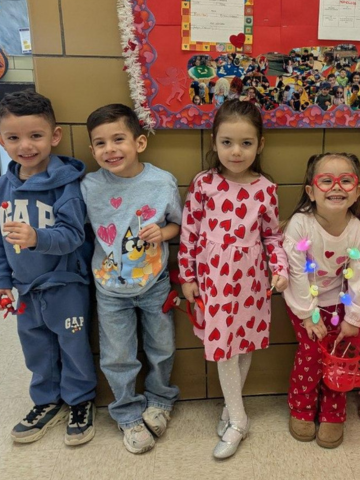 Four children dressed up for Valentine's Day.