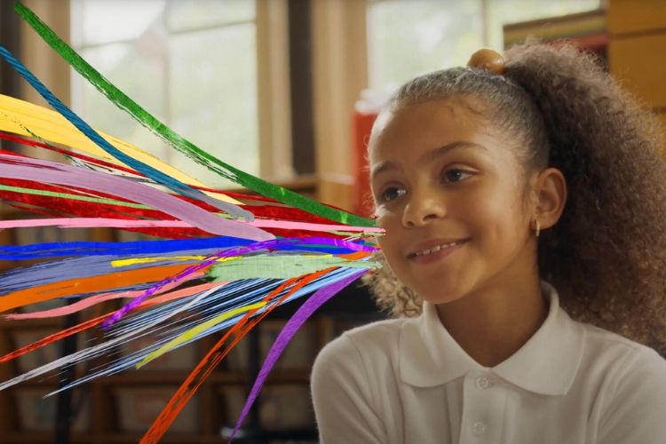 Smiling girl with colorful brushstrokes emanating from her mouth.
