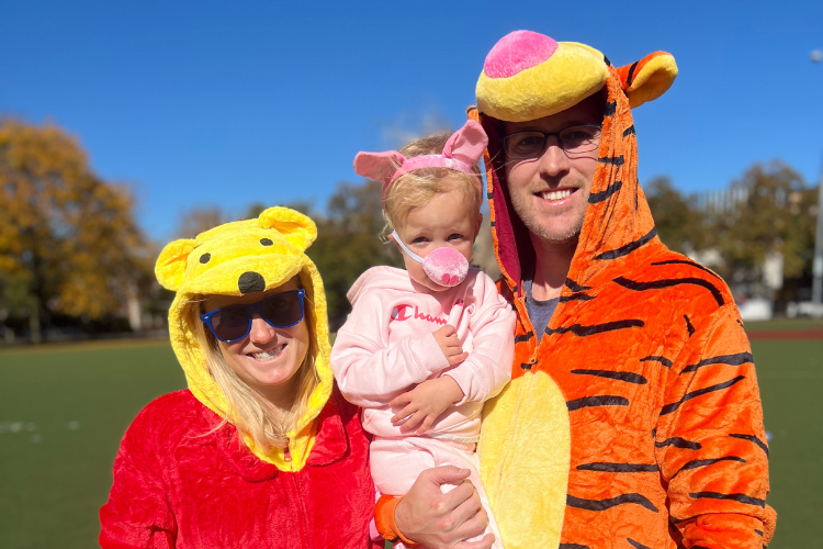 Family in Winnie-the-Pooh character costumes.