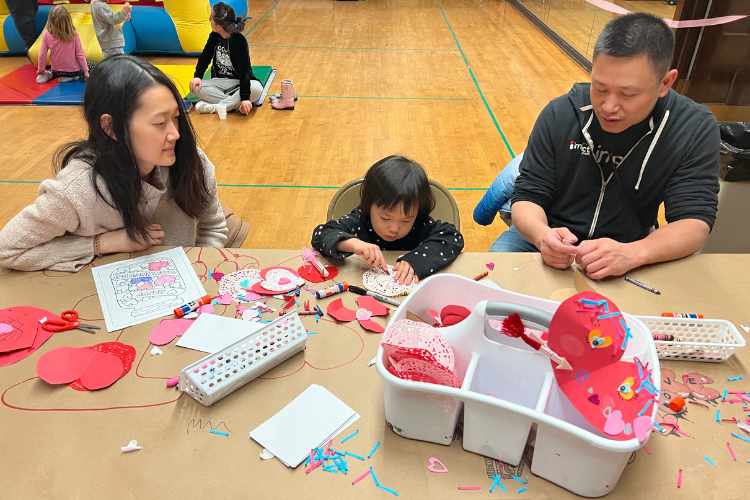A family crafts together making Valentines.