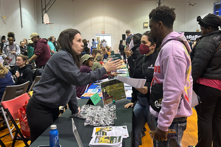 A job fair inside a gymnasium.