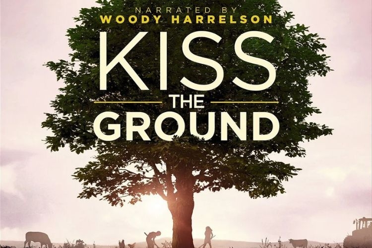 Poster for the documentary Kiss the Ground, featuring a large tree, farmland, and silhouettes.
