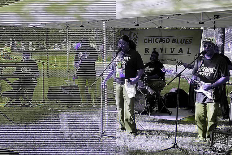 A blues band performs under a canopy with a Chicago Blues Revival banner in the background.