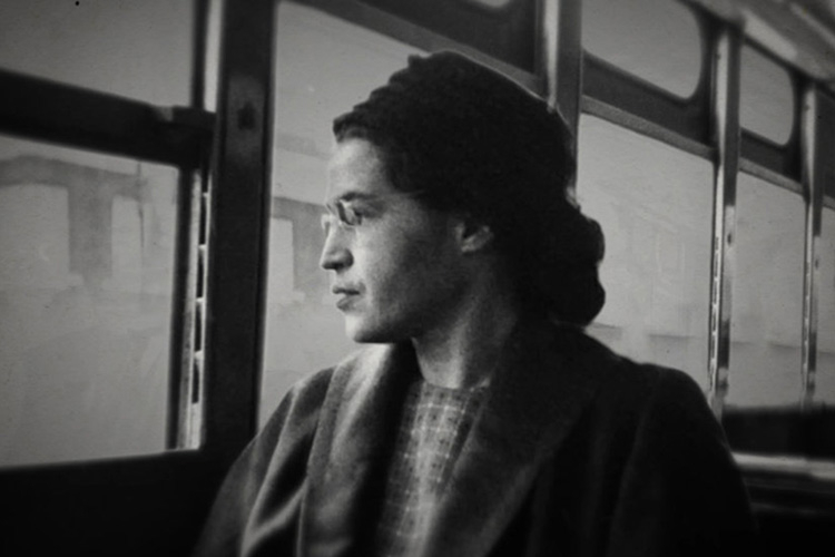 Black and white photograph of Rosa Parks looking out a bus window.