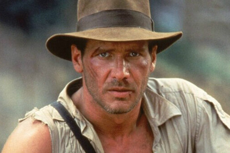 Photograph of Indiana Jones wearing his iconic fedora, looking directly at the camera.