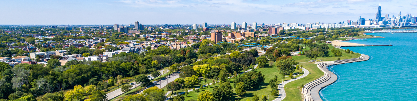 Aerial photograph of Chicago's coastline, with green parks bordering the bright blue lake.