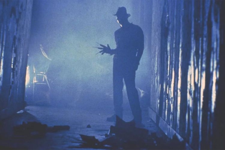 Photograph of Freddy Krueger in a dark, misty corridor, showing his signature bladed glove.