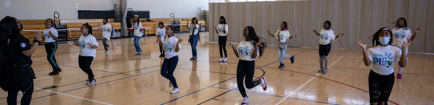 Girls dancing in a gym.