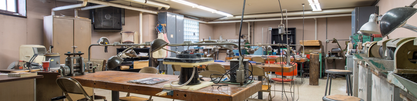 Lapidary Studios.png Jewelry studio workshop with workbenches, tools, and equipment.