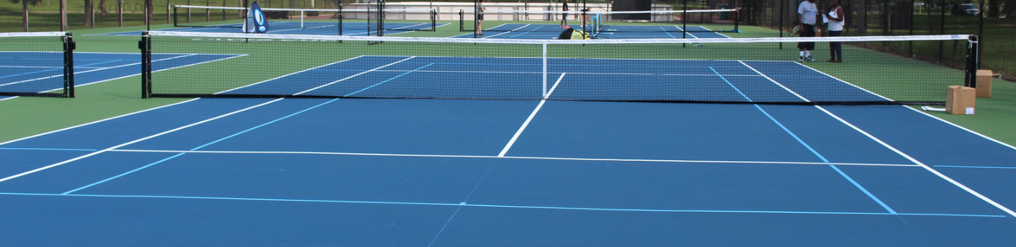 Tennis Courts.png Blue and green tennis courts on a sunny day.