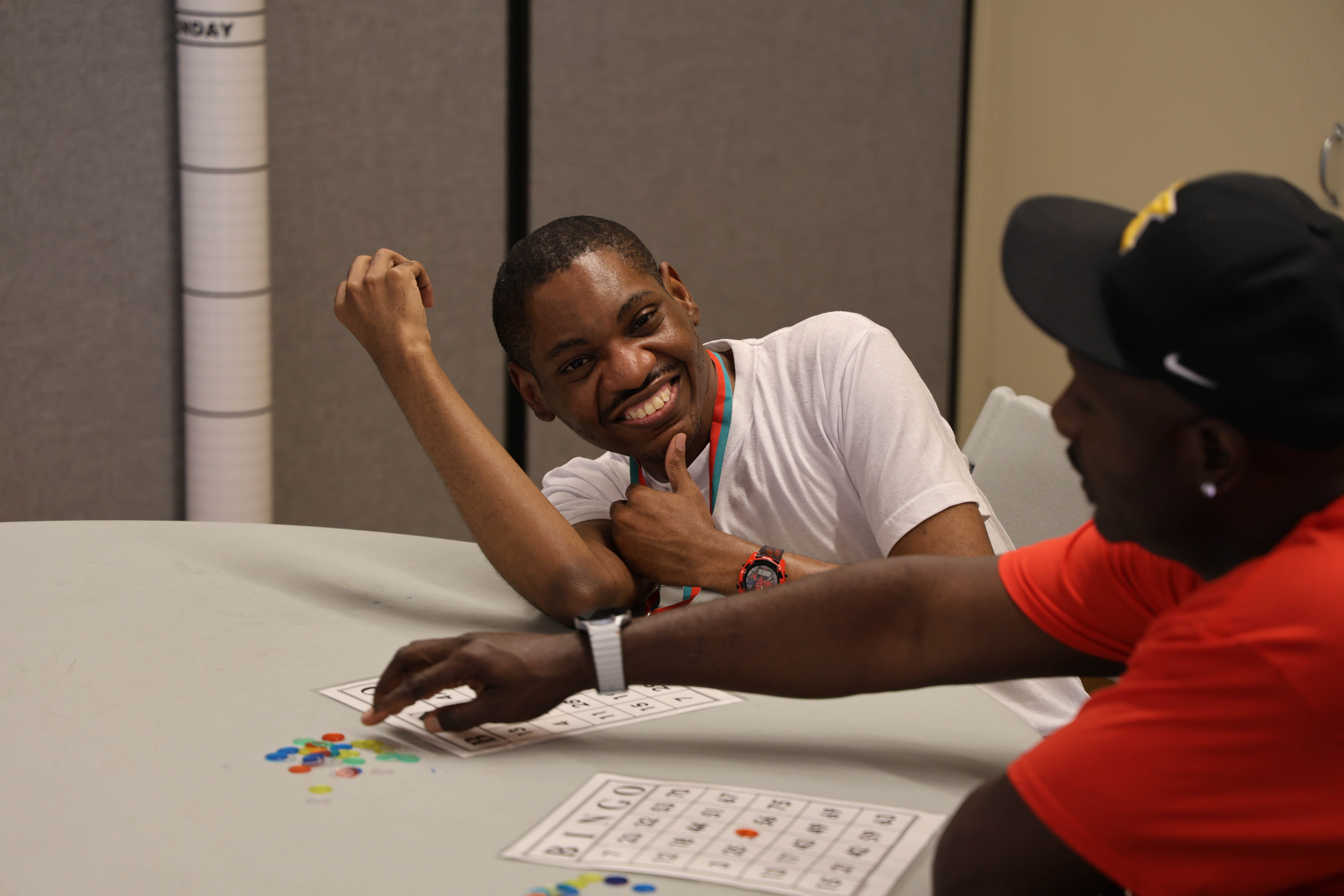 Two campers smile and play bingo.