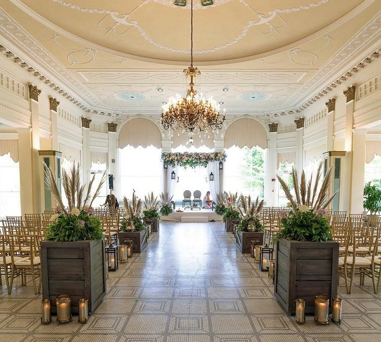 Ornate wedding venue decorated with floral arrangements and candles.