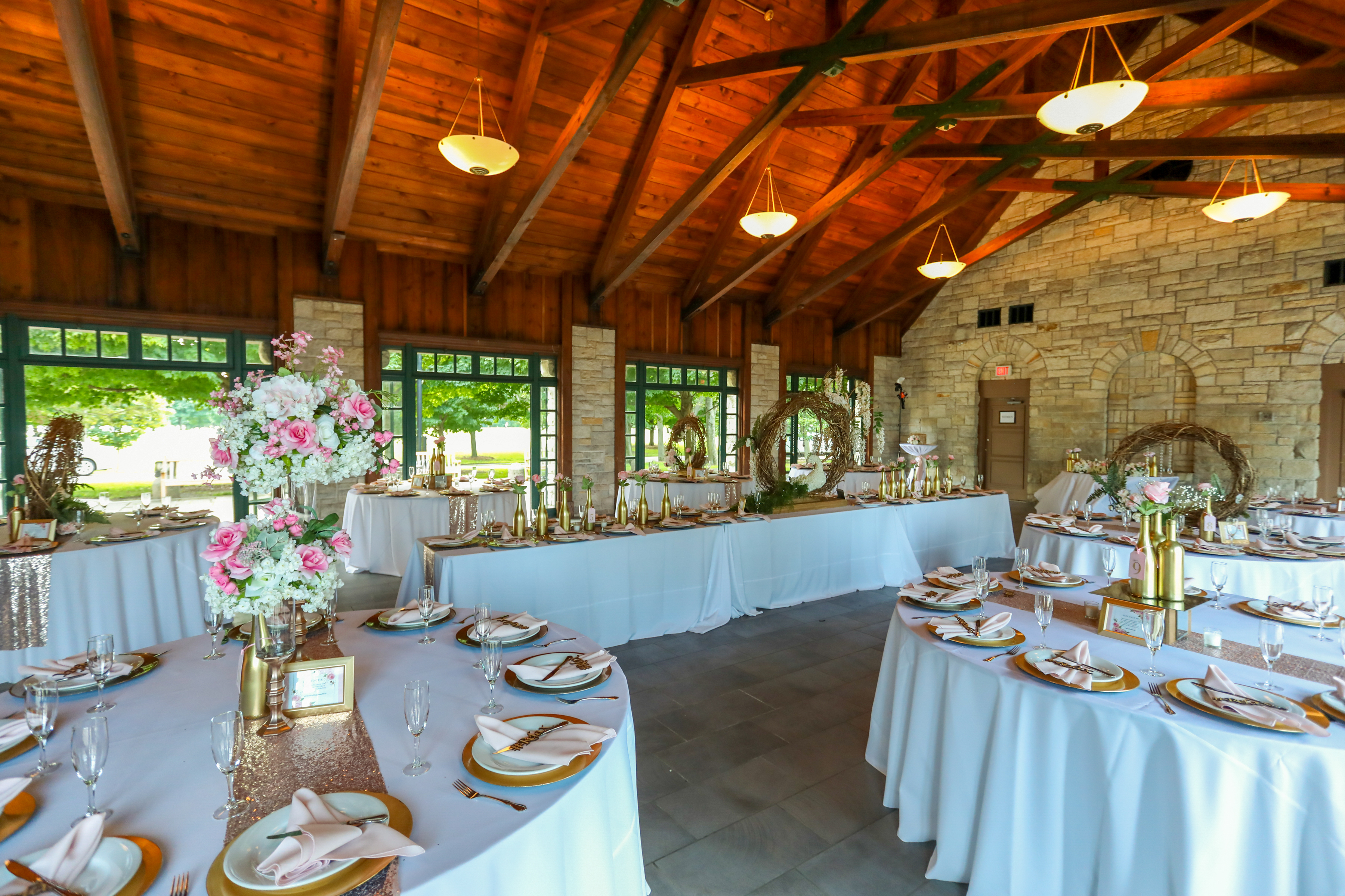 Wedding reception hall decorated with pink and gold accents.