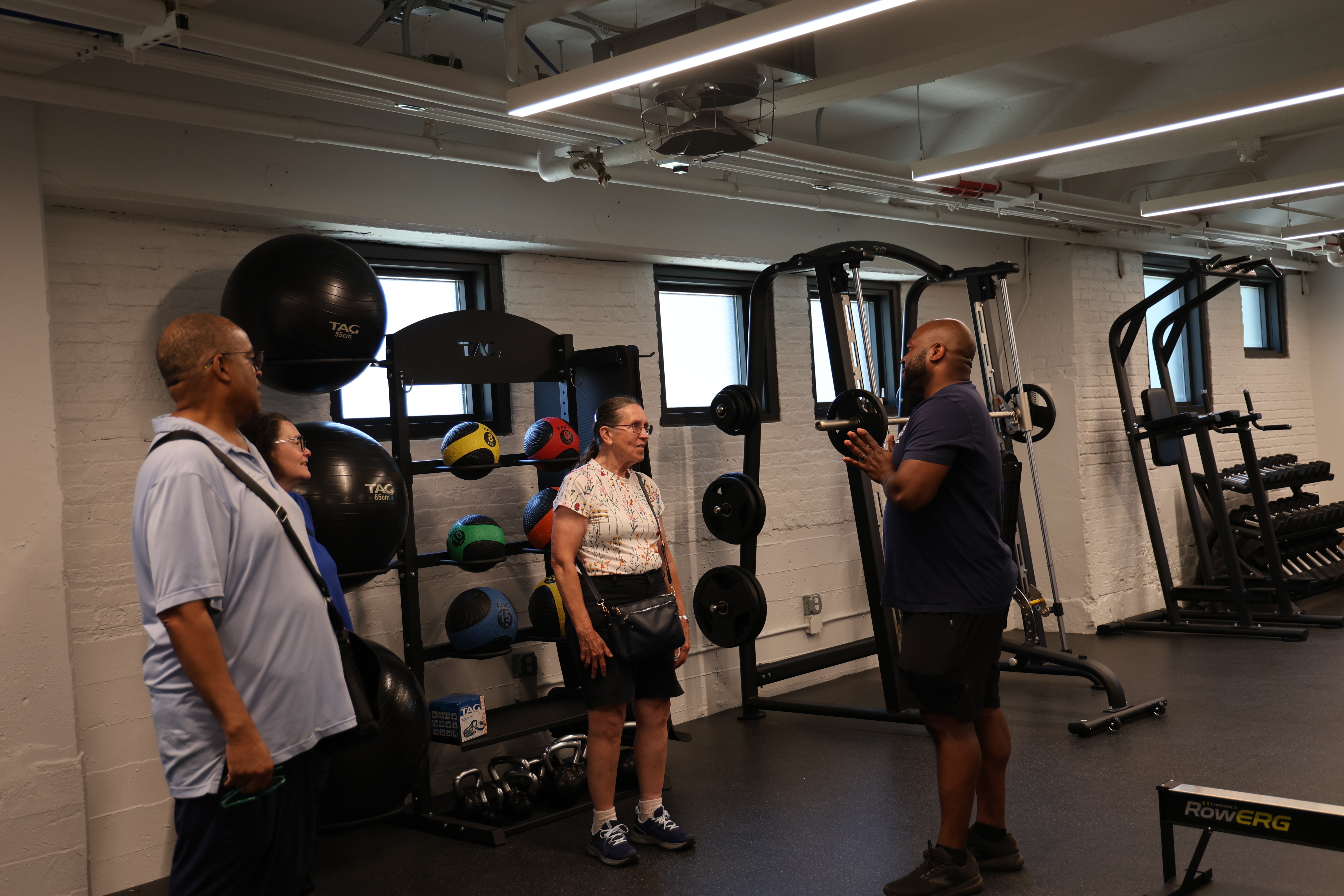 People converse in a newly renovated fitness room.
