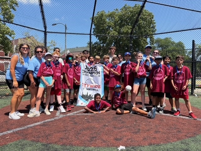 Youth softball team poses with championship banner and medals.
